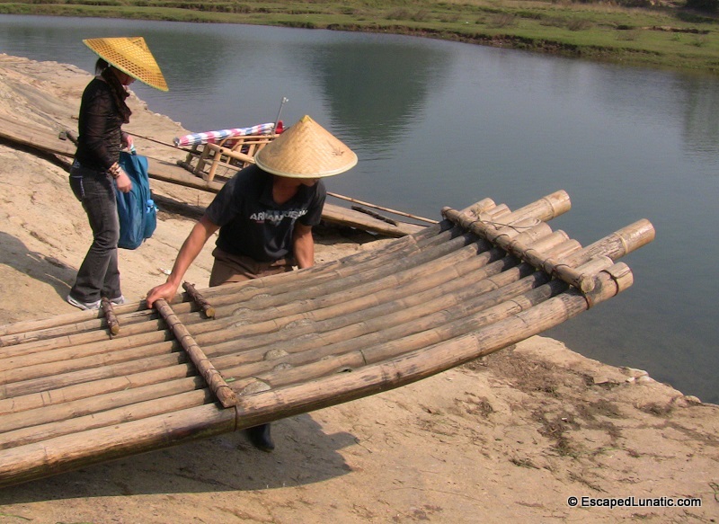 Our captain shoving and dragging the raft over a dam.