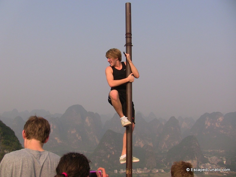 Climbing the poll on top of Moon Hill near Yangshuo