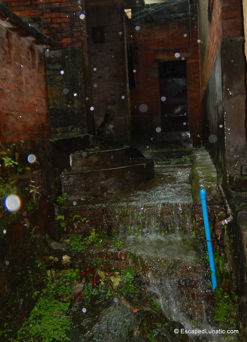 Waterfall on a village walkway