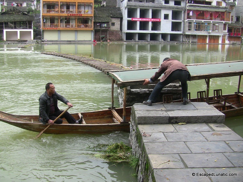 Boat passing through one of the hopping bridges in FengHuang